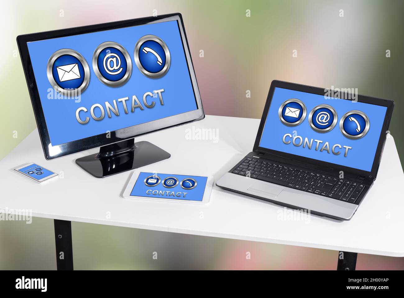 Contact concept shown on different information technology devices Stock Photo
