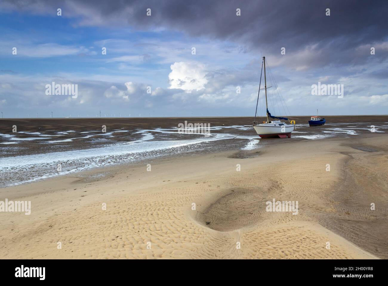 Meols, UK: Fishing boat moored on the beach at low tide on the North Wirral coastline. Stock Photo