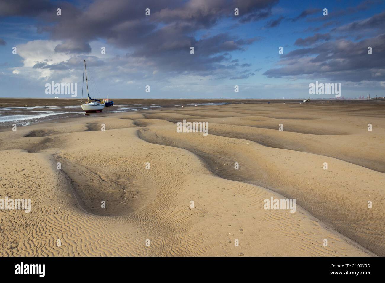 Meols, UK: Fishing boat moored on the beach at low tide on the North Wirral coastline. Stock Photo