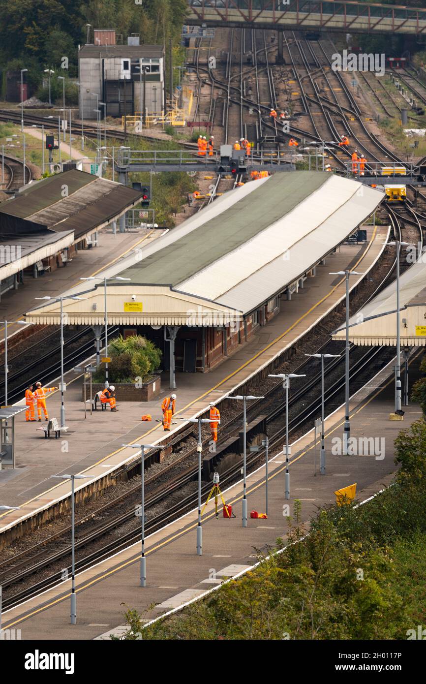 Aerial view on Network Rail railway workers undertaking essential planned maintenance work on railway tracks at a closed Basingstoke train station, UK Stock Photo