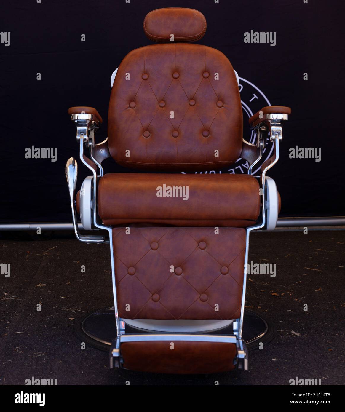 Barber shop chair on black background Stock Photo - Alamy