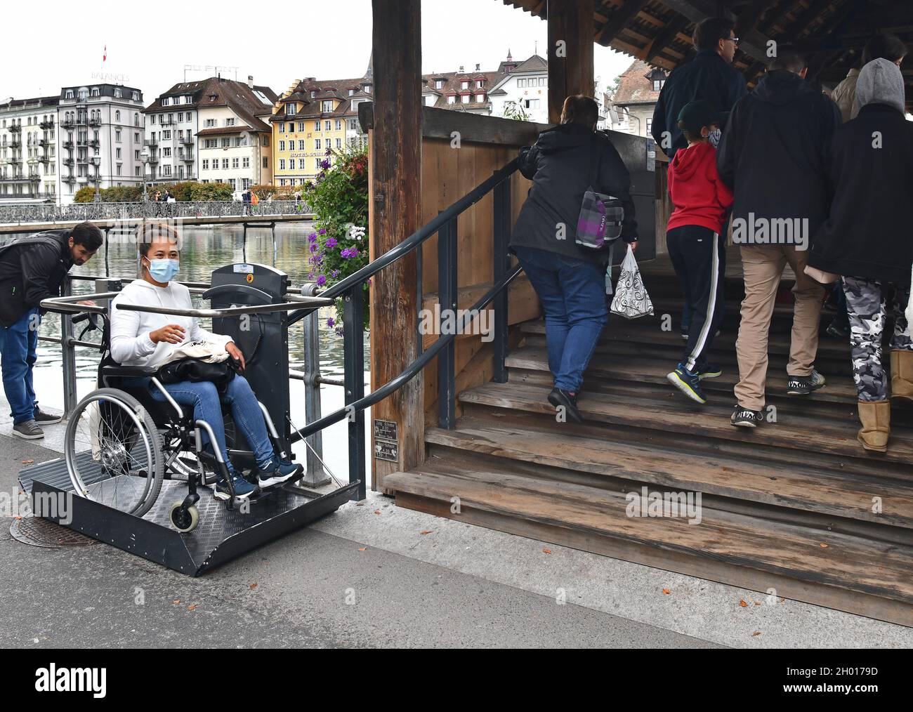 Wheelchair Access lift being used by young woman on Chapel Bridge