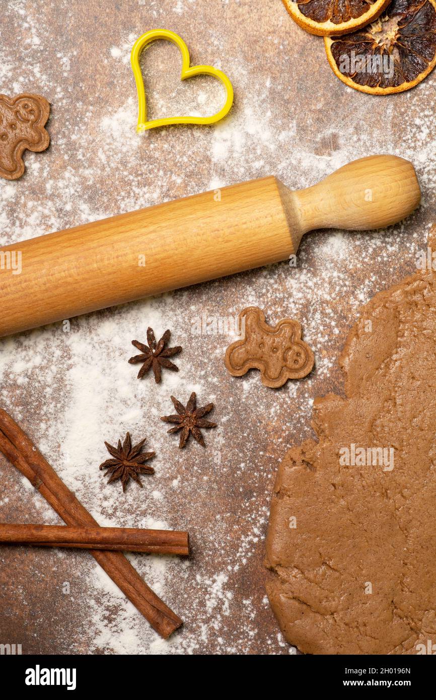 The kitchen work surface is sprinkled with flour. The overwhelming scent of cinnamon and gingerbread cookies. The sweet smell of Christmas! Stock Photo