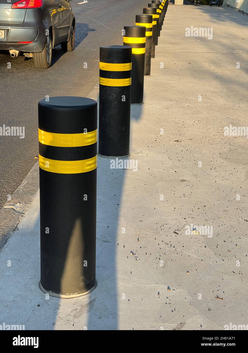Vertical shot of traffic road bollards protectivng pedestrian sidewalk ...