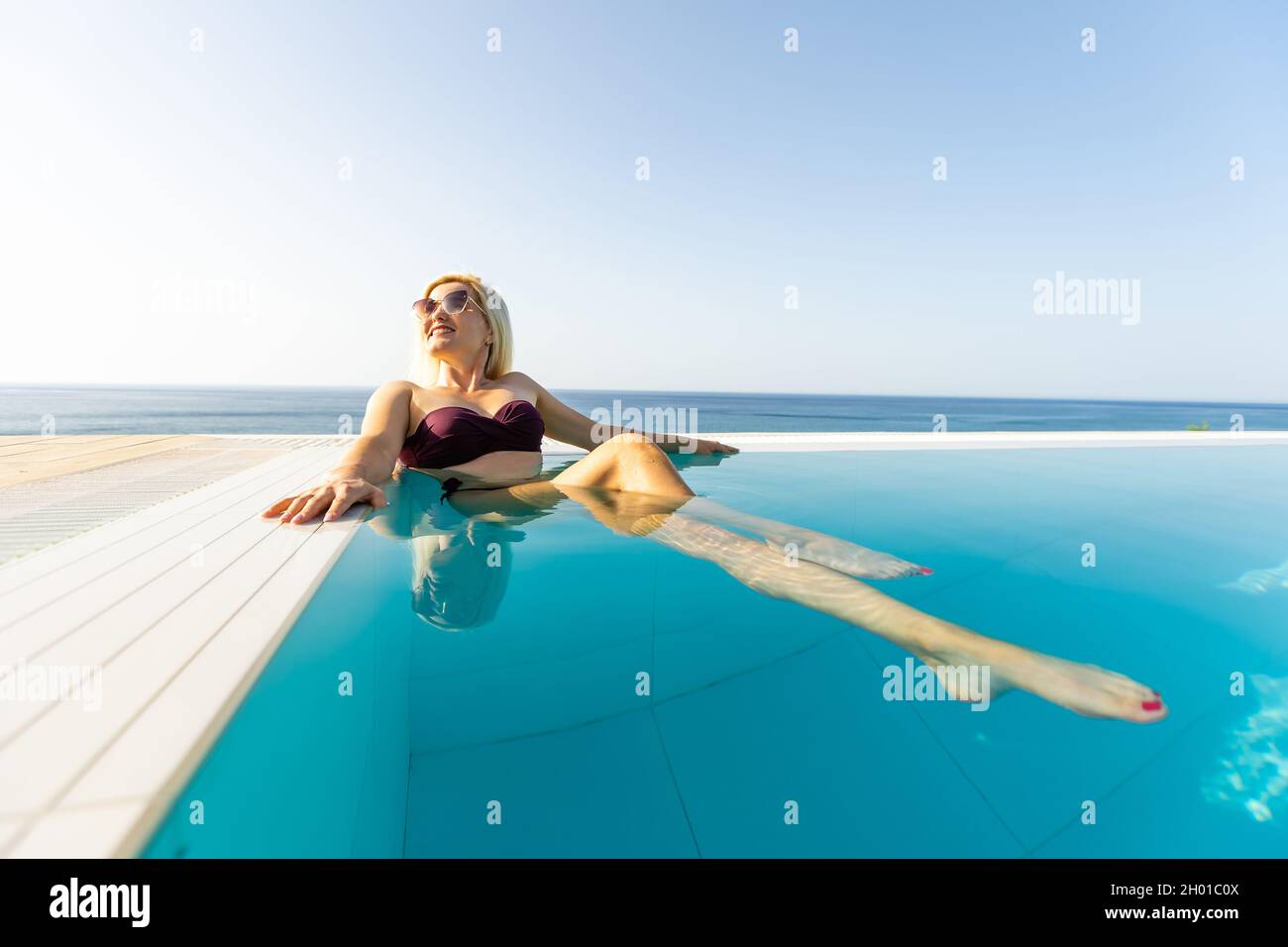 Young woman sunbathing near swimming pool Stock Photo Alamy