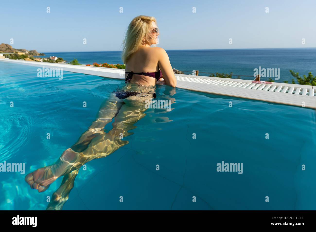Young woman sunbathing near swimming pool Stock Photo Alamy