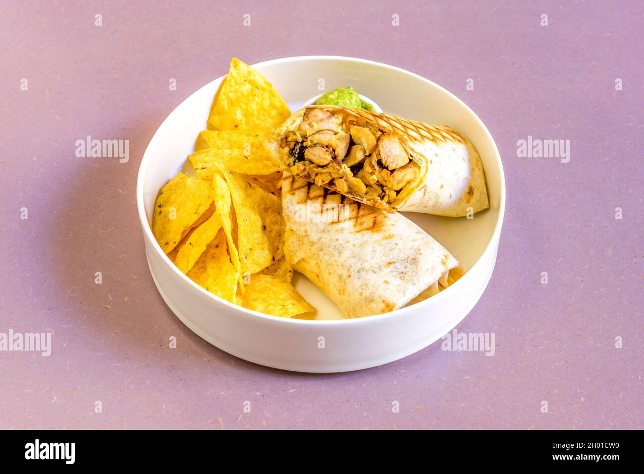 Chopped chicken wrap with sweet yellow curry sauce with corn chips Stock Photo