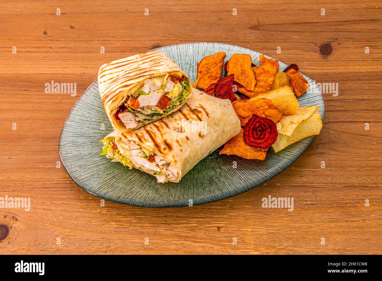 Chicken Vegetable Wrap Wrapped with Grilled Tortilla with Fried Vegetable Chips Stock Photo