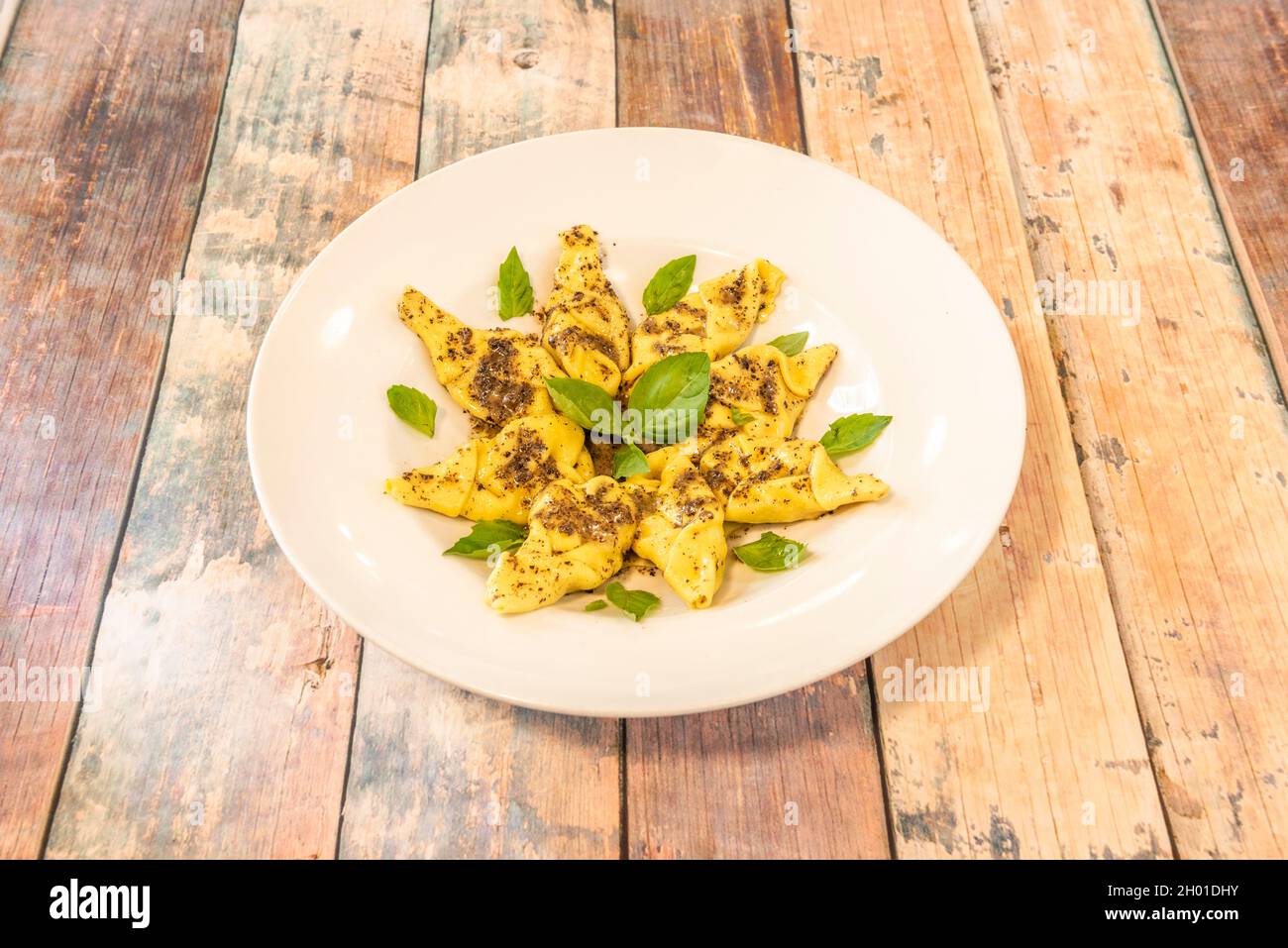 Italian recipe for ravioli with ricotta and truffle sauce with basil