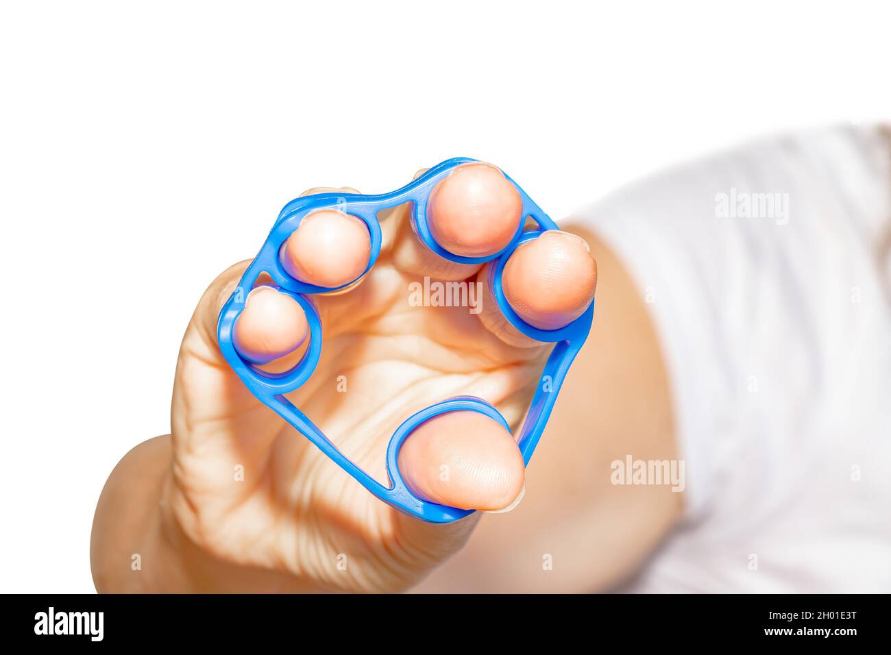 Hand Grip Strengthener in blue in the hand of a woman isolated on white background Stock Photo