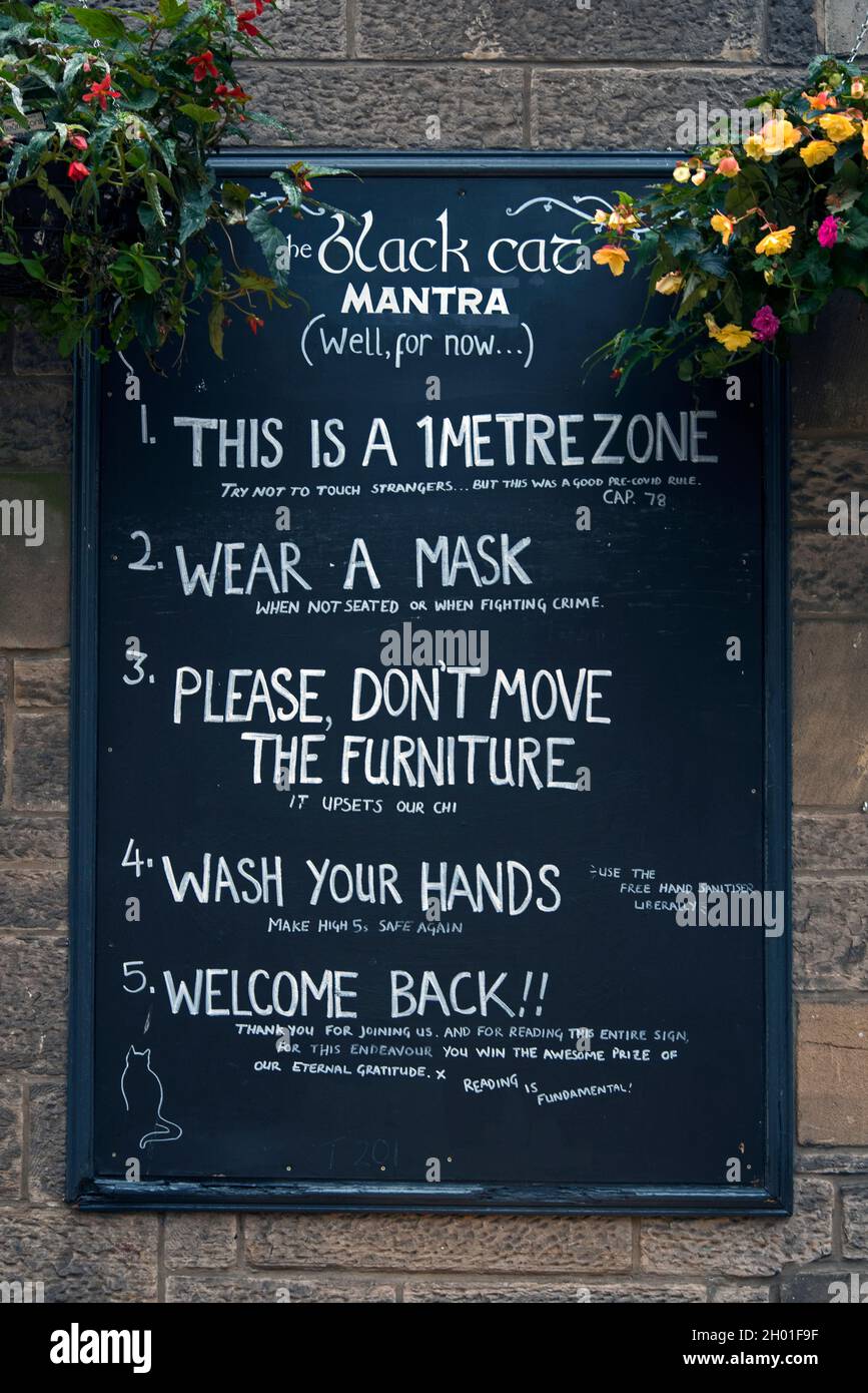 Notice board outside the Black Cat Bar setting out the rules during the covid pandemic. Rose Street, Edinburgh, Scotland, UK. Stock Photo