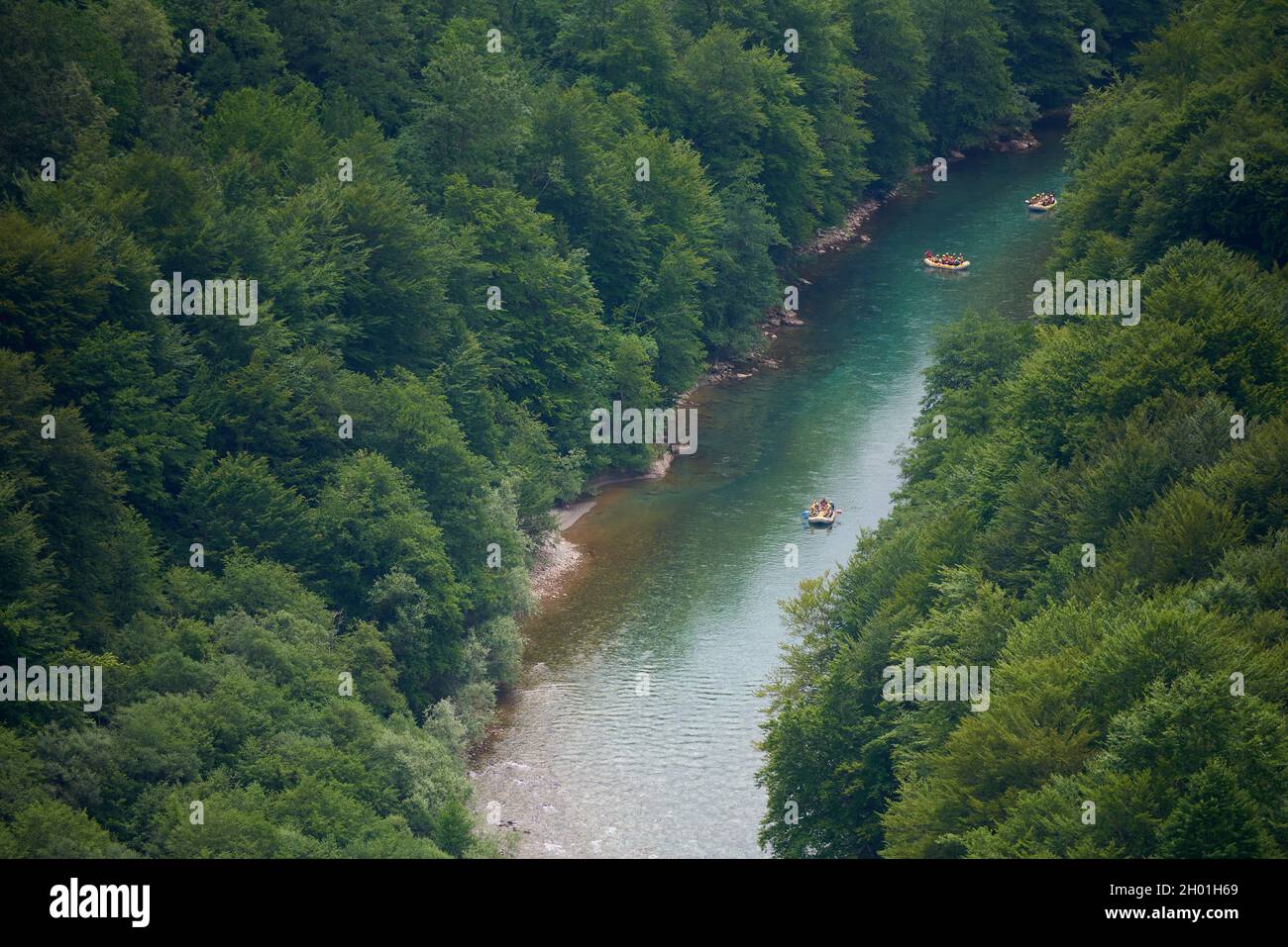 Tourists on boats are rafting on a mountain river, aerial view Stock Photo