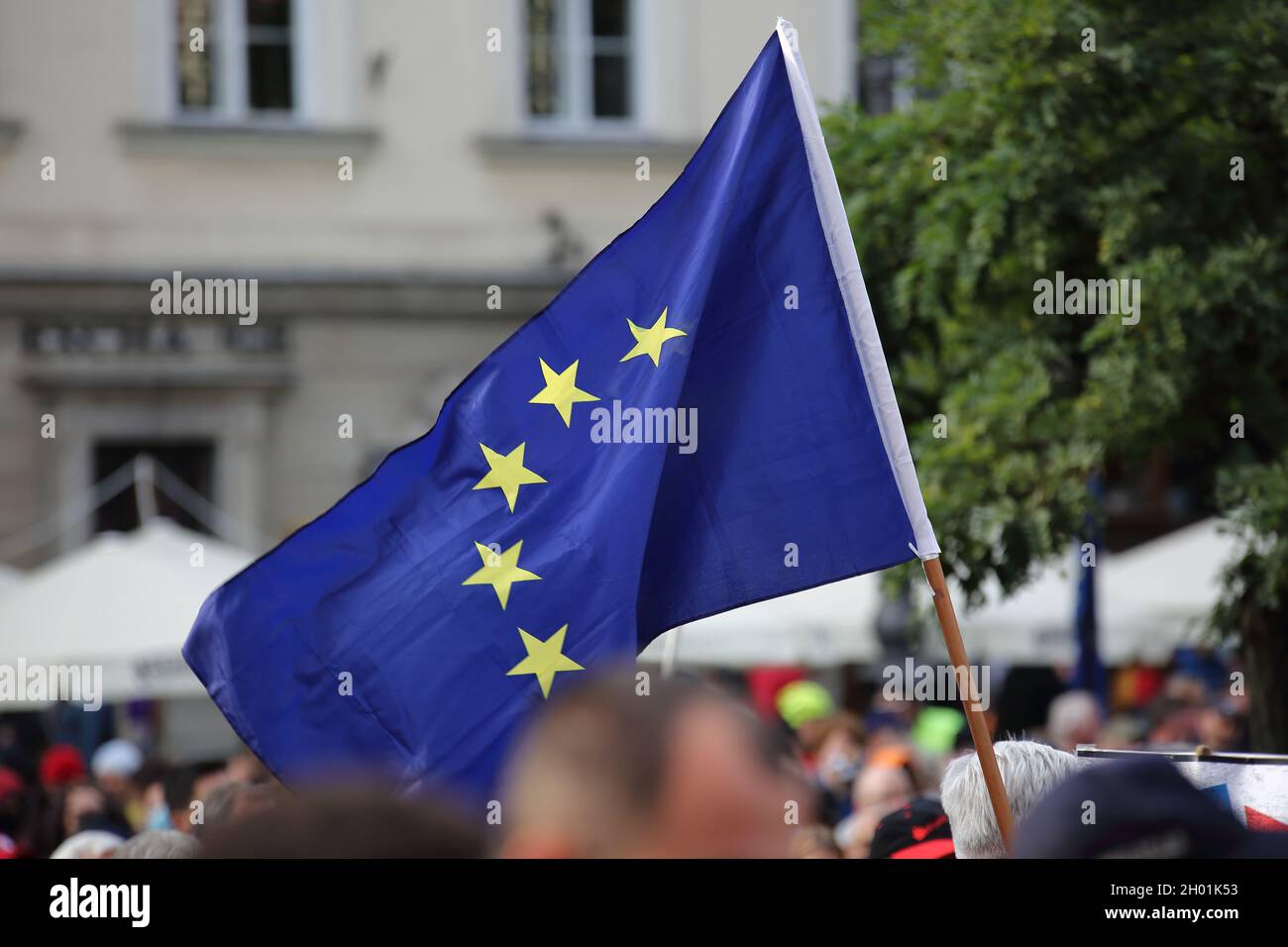 Big EU flag on flagpole waves during massive street demonstration in Krakow, Poland, to support Polands memebrship in EU Stock Photo