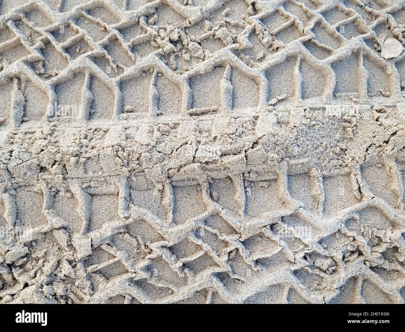 close up of tire track pattern in beach sand Stock Photo