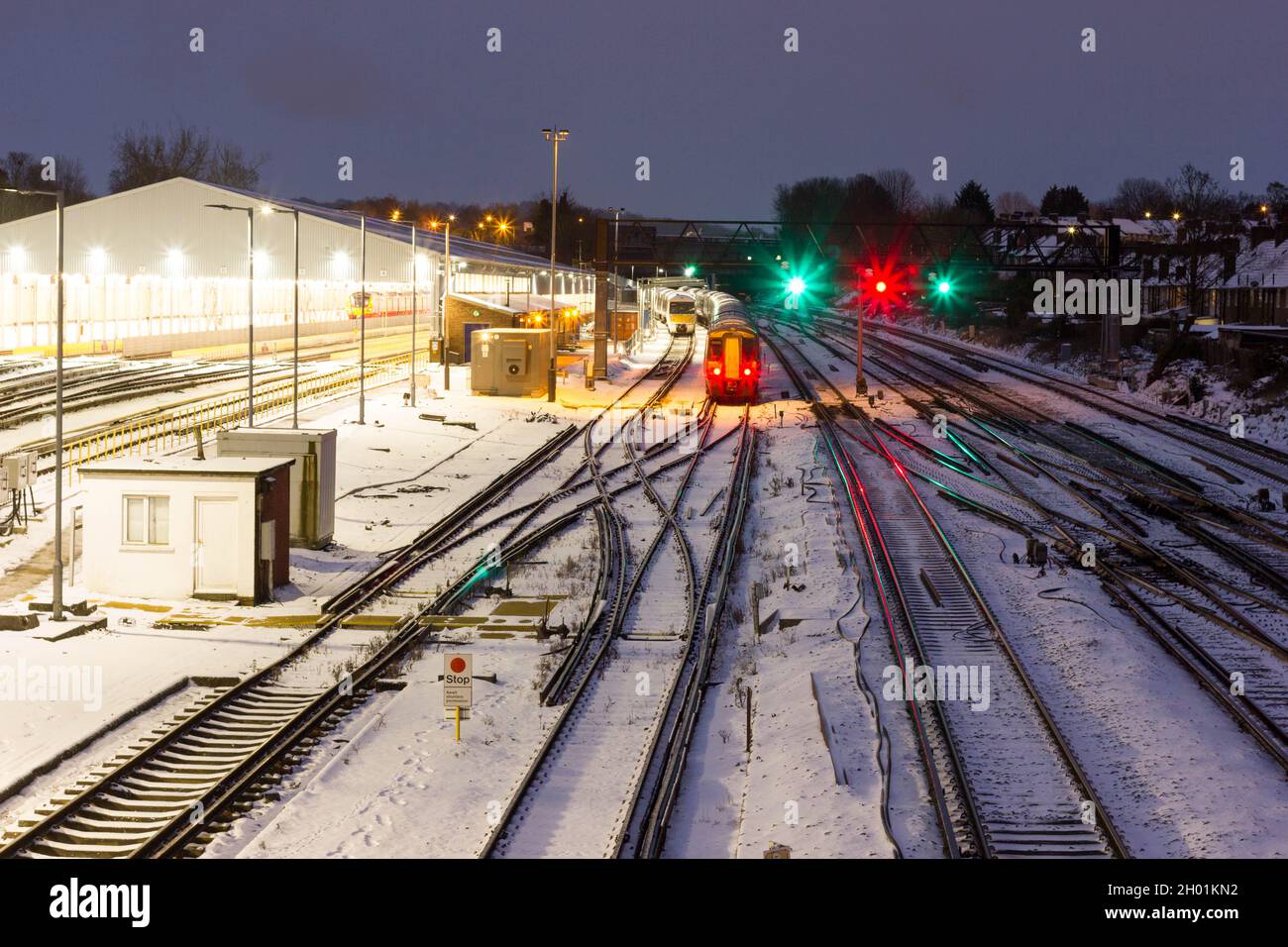 Trains stand still under heavy snow on national network railway tracks, traffic lights, South London England UK weather Stock Photo