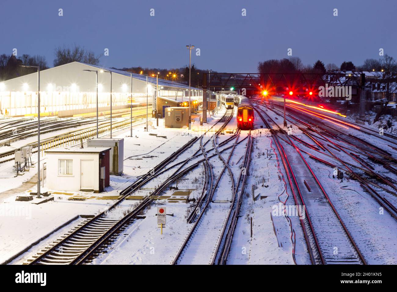 Trains stand still under  heavy snow in winter on national network railway tracks , traffic signalling , South London England UK weather Stock Photo