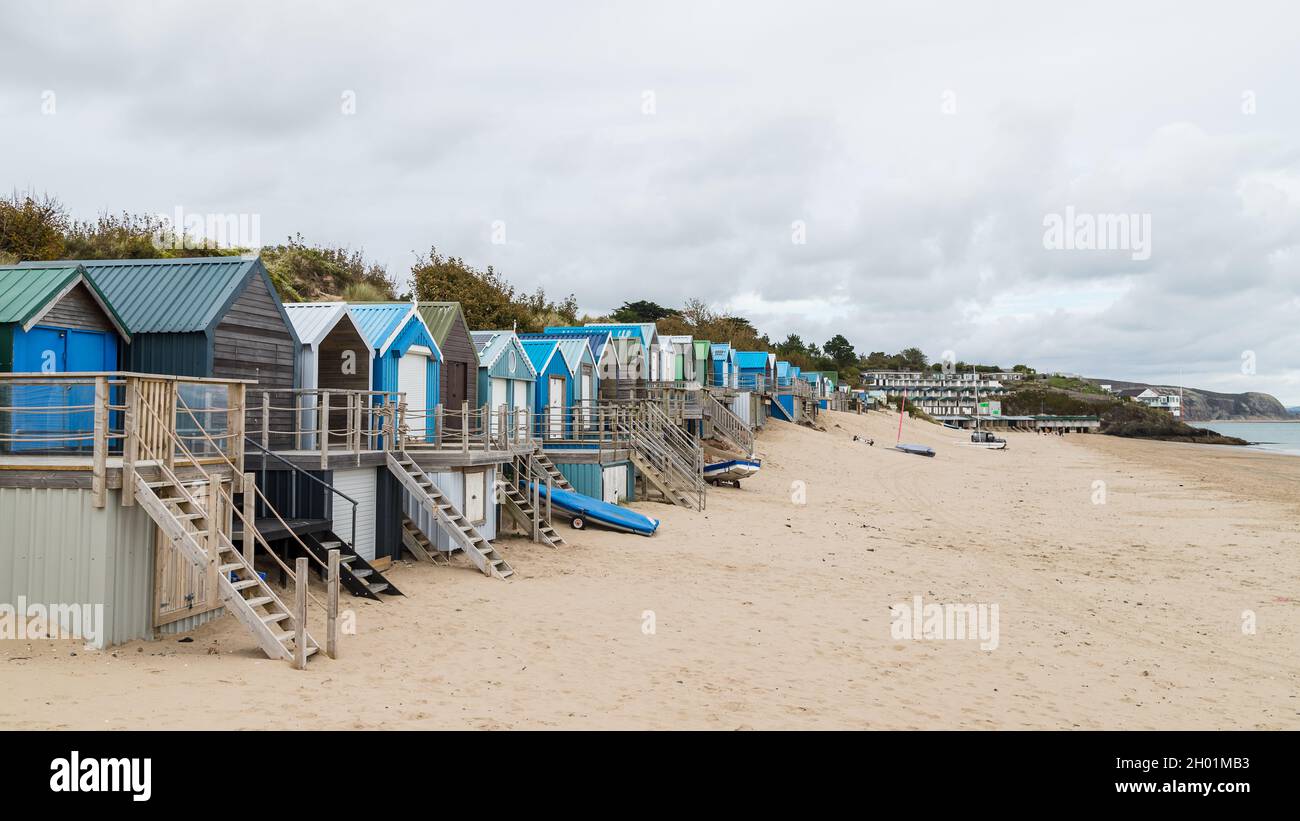 Abersoch beach huts lined up by the sand dunes on the North Wales coast in October 2021. Stock Photo