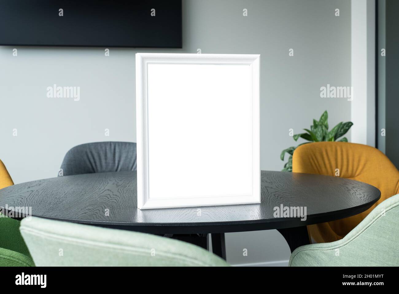 Blank award template mockup in modern office room. Empty picture frame. Insert your text or design for certificate or diploma. Stock Photo