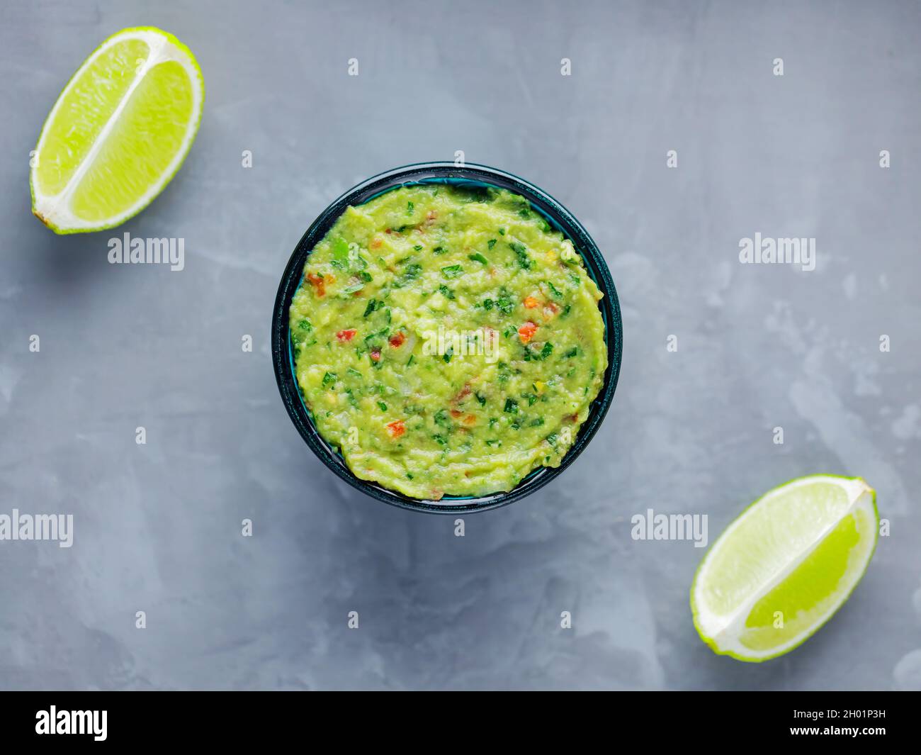 Guacamole bowl on a gray background. Traditional mexican dip sauce guacamole in the bowl. Mexican cuisine. Copy space. Top view Stock Photo