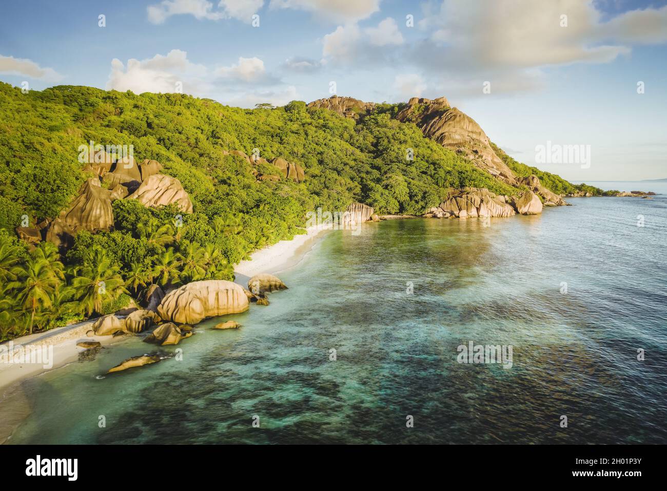 Golden sunset vibe colors at Anse Source D Argent exotic beach at Seychelles. Aerial drone above photo Stock Photo