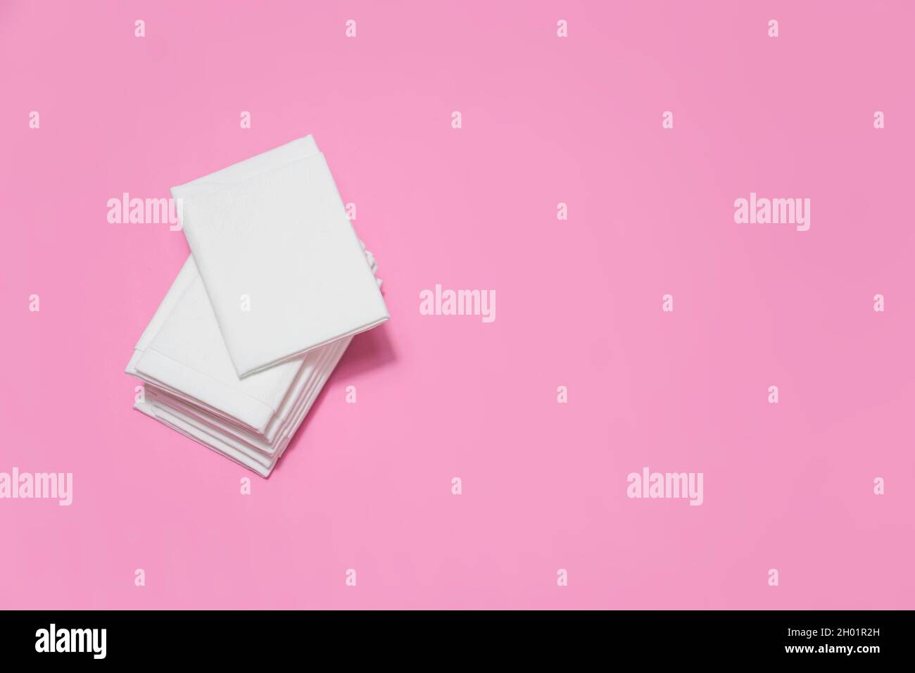 White paper tissues on dark pink background. Stock Photo