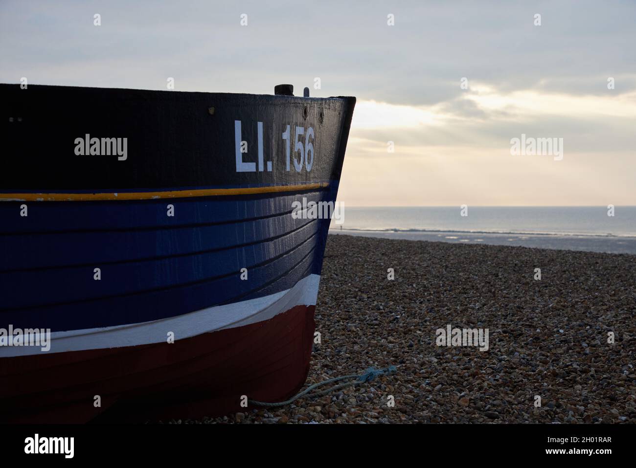 Small commercial fishng boat seen on the beach of Bognor Regis. Stock Photo