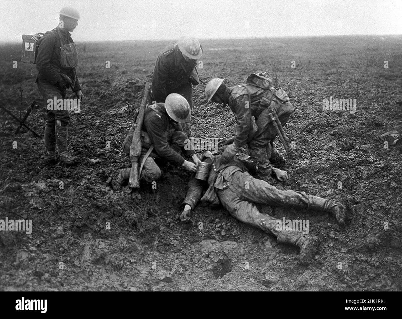 Canadian soldiers taking care of a fallen German on the battlefield at the Battle of Vimy Ridge in 1917. Stock Photo