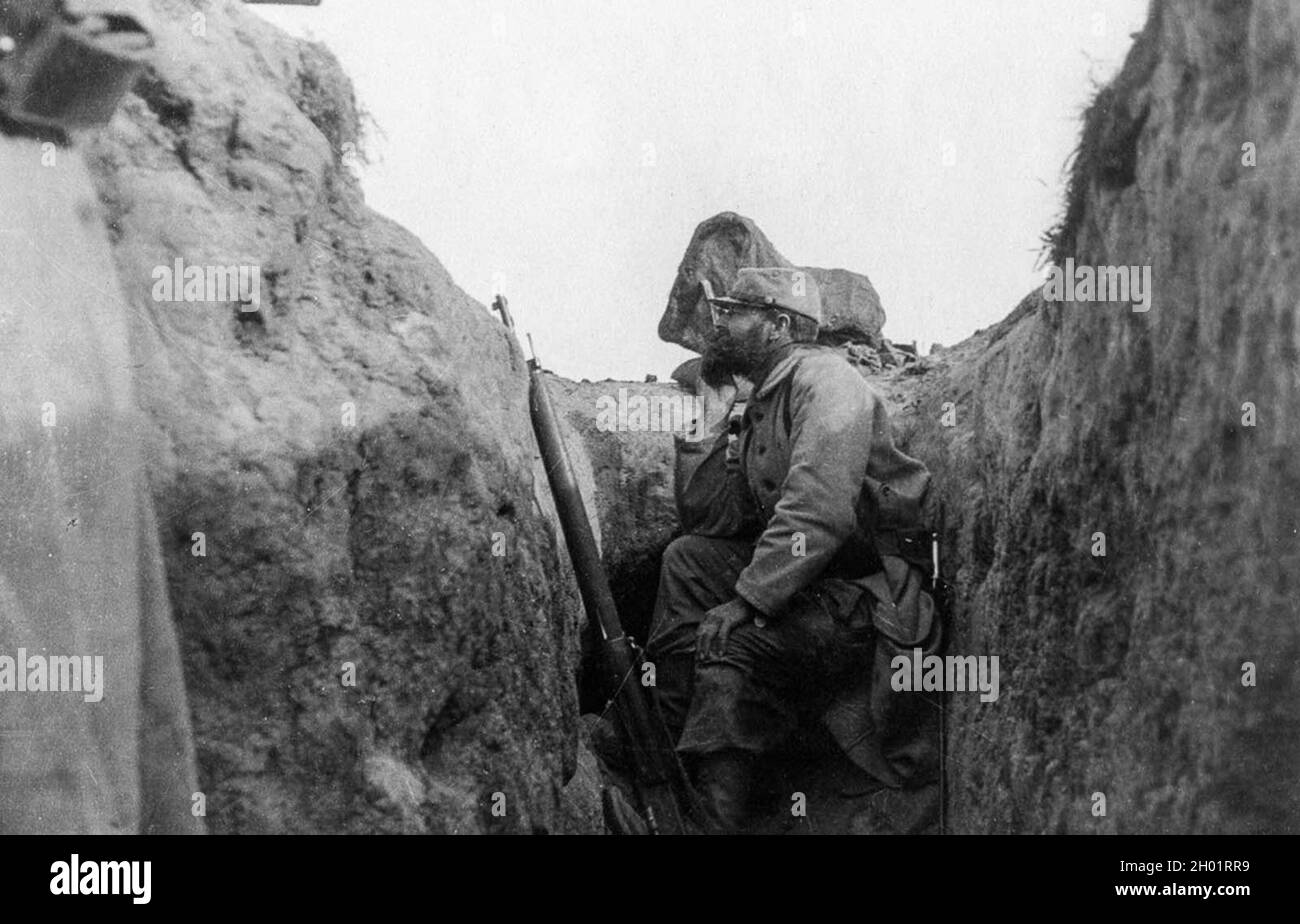 A French soldier peers over the edge of a trench. Stock Photo