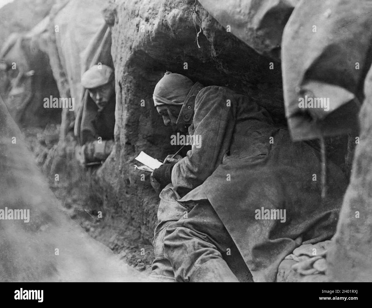 Soldiers in trenches writing letters home. Stock Photo
