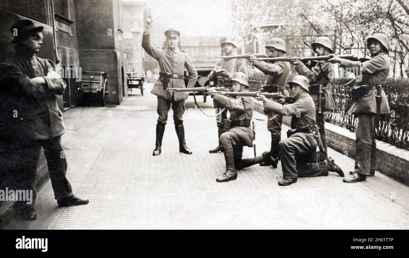 The execution of a German communist after WW1. There are several elements (the insouciance and dress of the victim and the clumsy way some of the firing squad are holding their rifles) that suggest this is posed for propaganda rather than a real execution. Stock Photo