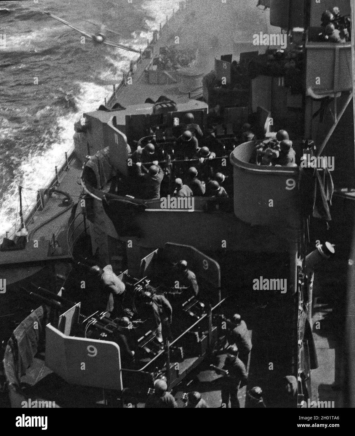 A kamikaze plane (top left) seconds from hitting the battleship USS Missouri. Stock Photo