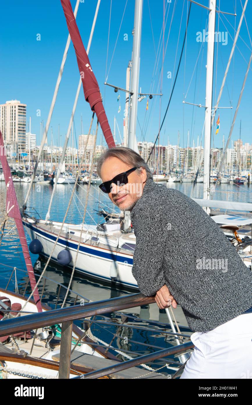 attractive mature man strolling along the marina in a city Stock Photo ...