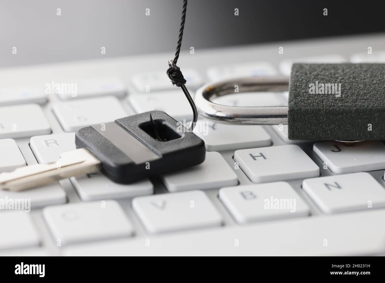 Key and lock on white computer keyboard closeup Stock Photo