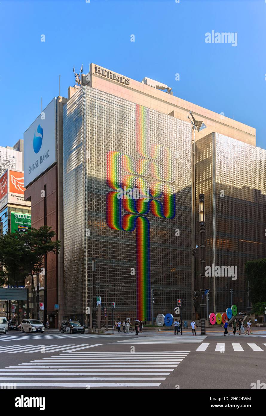 tokyo, japan - august 30 2021: Rainbow motif by Argentine artist Julio Le Parc on French luxury fashion brand Hermès building designed with translucen Stock Photo