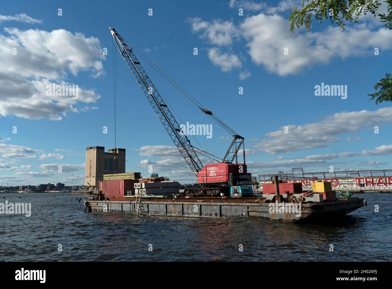 In Tribeca, a crane in the Hudson River's Pier 32 pile field was hired by the Hudson River Park Trust to install an improved habitat for oysters. Stock Photo