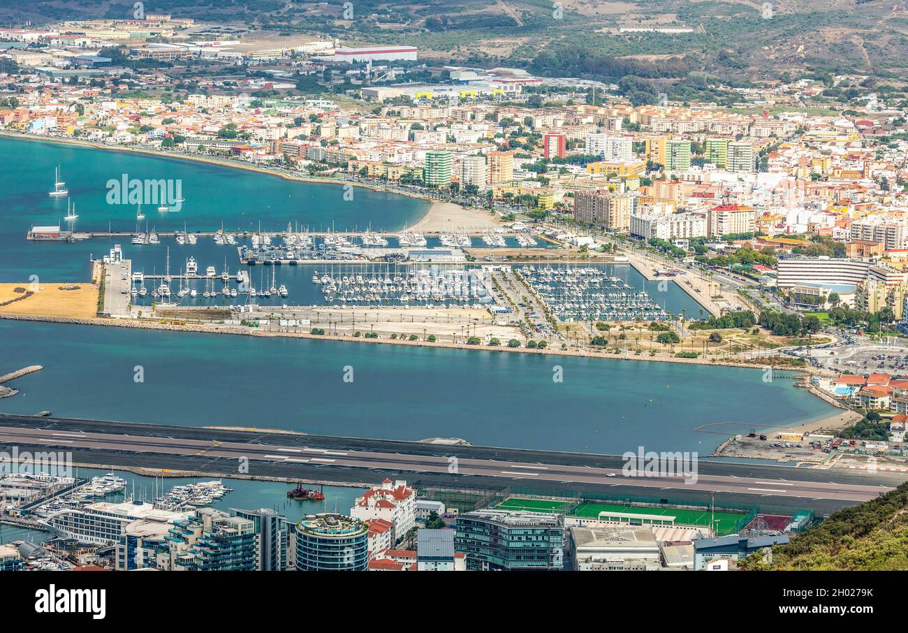 Elevated view of part of Giibraltar, bottom, over the airport runway to Alcaidesa Marina in La Línea de la Concepción, Spain. Stock Photo