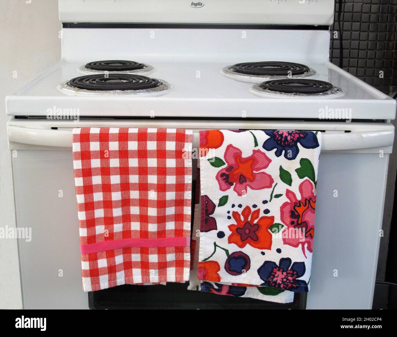 White stove with coorful dish towels Stock Photo
