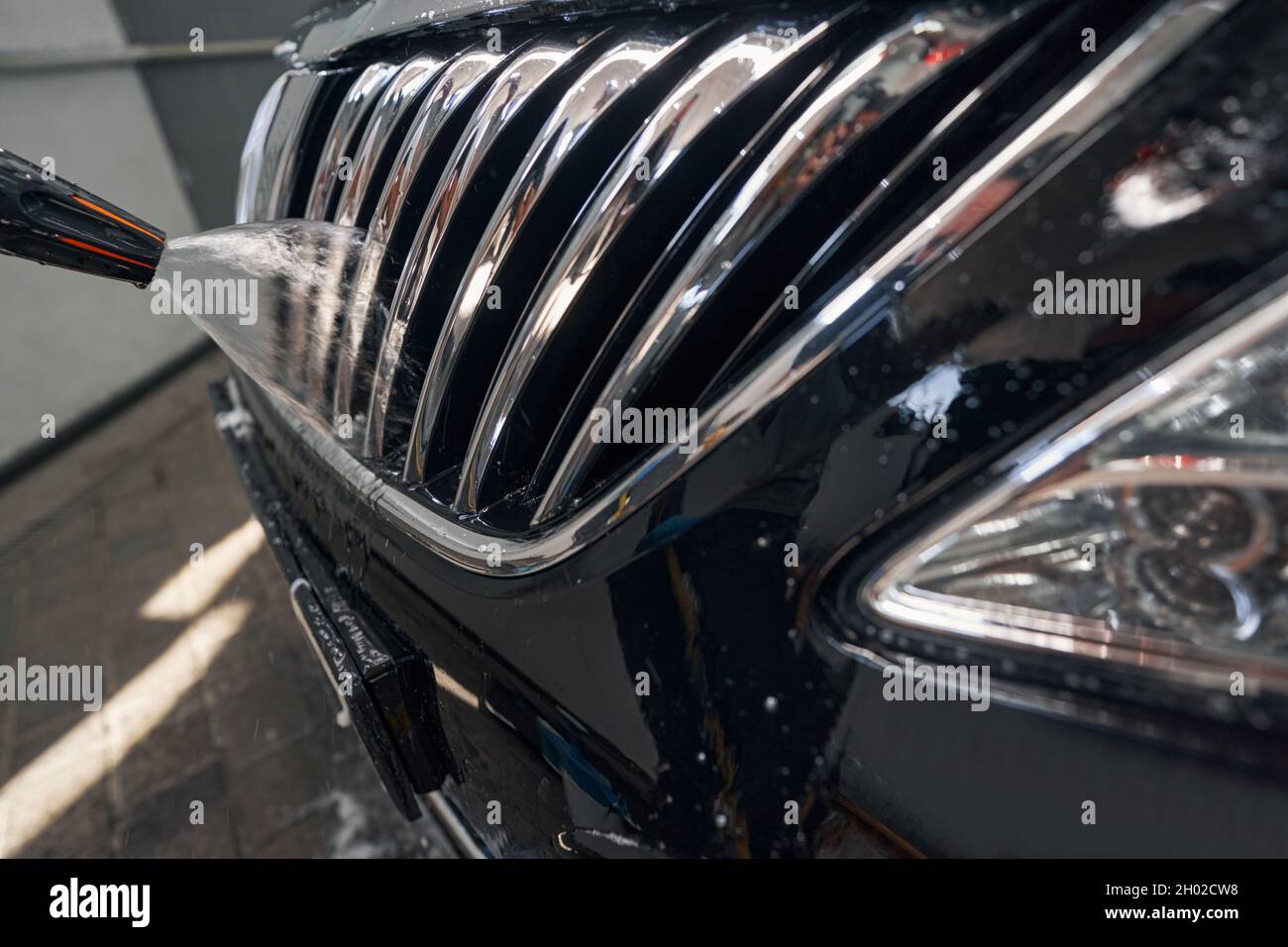 Photo of washing car radiator grille with high pressure spray Stock ...