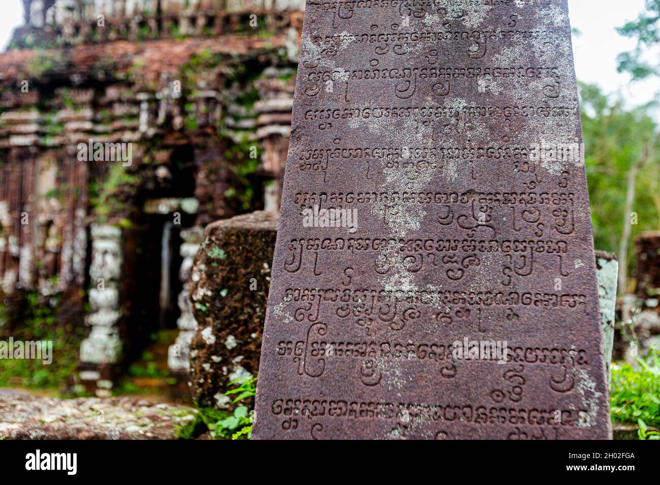 Stone inscription writings in front of ancient building at My Son ruins. Stock Photo