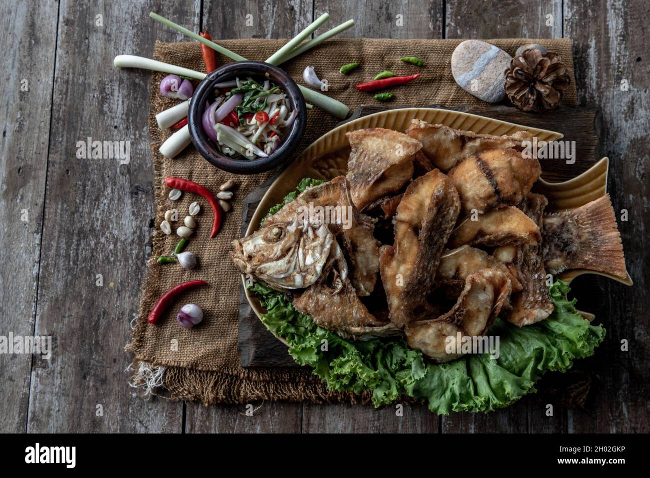Deep fried Tubtim fish with fish sauce on vintage wooden, The perfect ...