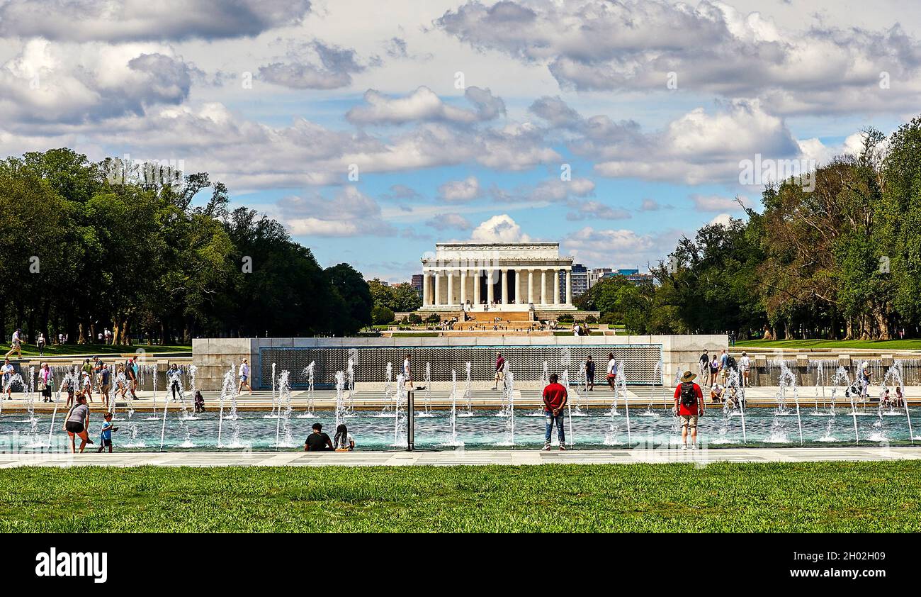 Washington DC, USA-August 19, 2021: World War II Memorial with water fountain and tourists and the Lincoln Memorial in the background Stock Photo