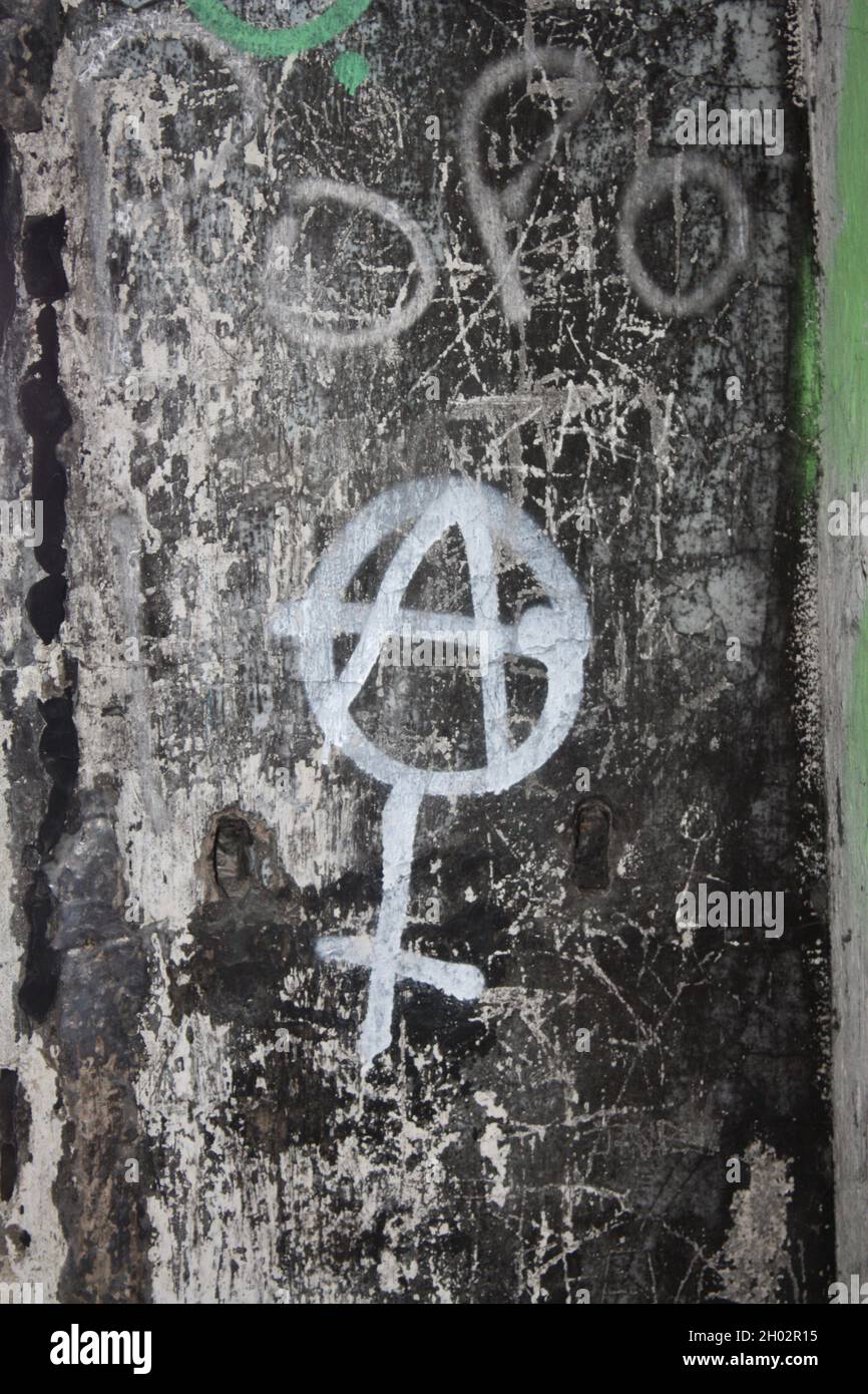 Graffiti from Cramond Island, near Edinburgh, depicting a female symbol combined with an anarchist symbol. Stock Photo