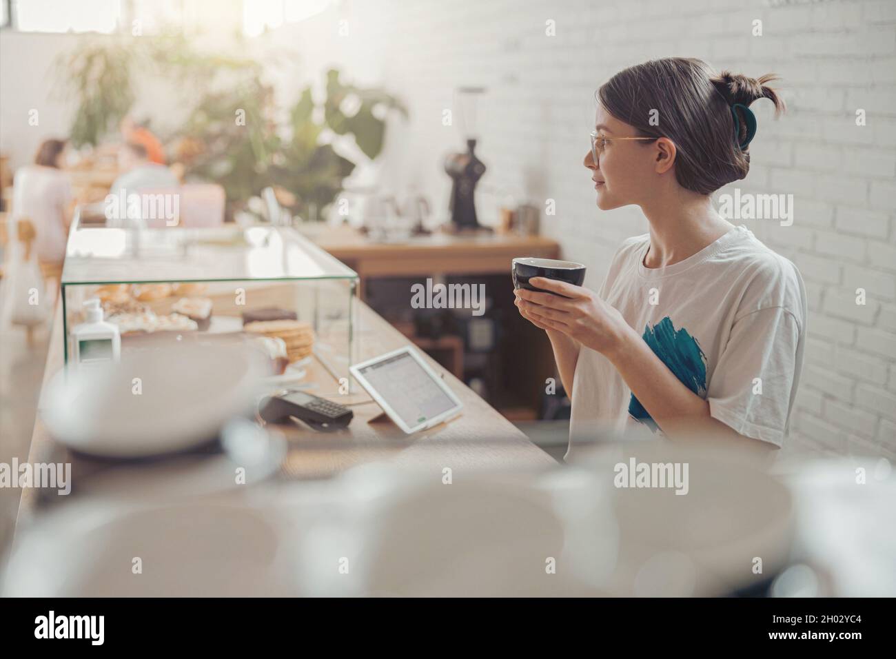 Nice young woman drinking coffee in coffee shop Stock Photo