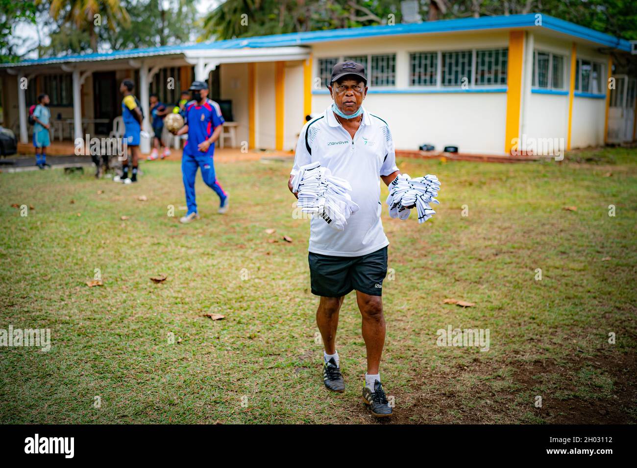 A sports coach carries brand new sports socks, donated with other sporting equipment by the United Through Sport charity, in between coaching sessions at a training hub in Mauritius, where youngsters are given free sports training and coaching on the island to help them pursue a career in professional sport. Picture date: Sunday October 10, 2021. Stock Photo