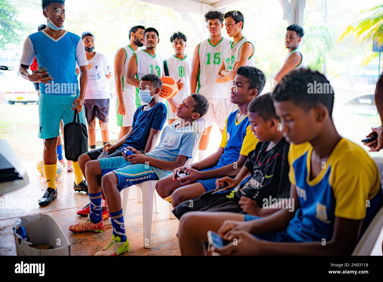 Young sporting hopefuls relax in between coaching sessions at a training hub in Mauritius, Africa, where youngsters are given free sports training and coaching on the island to help them pursue a career in professional sport. Picture date: Sunday October 10, 2021. Stock Photo