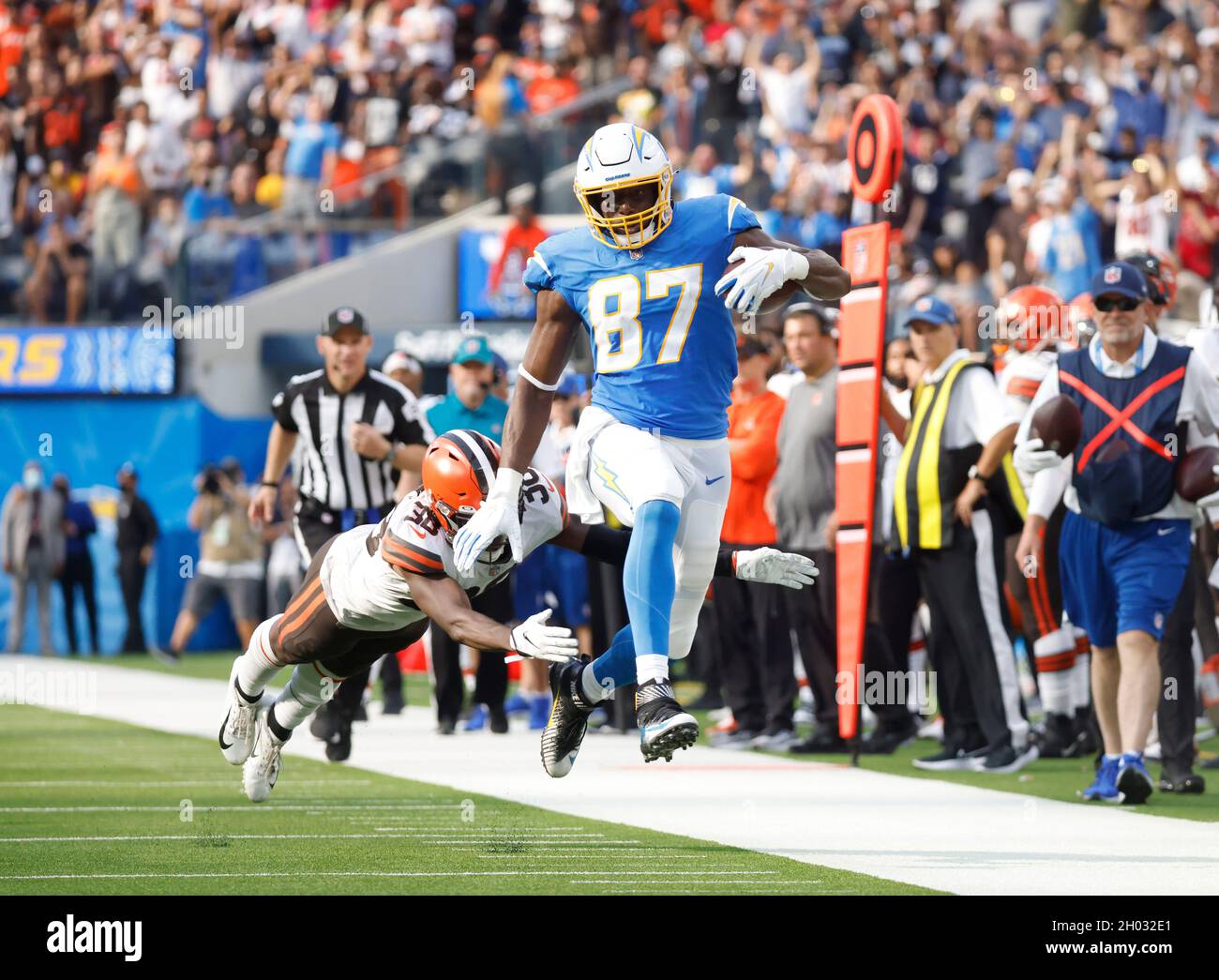 Inglewood, California, USA. 10th Oct, 2021. Los Angeles Chargers tight end Jared Cook (87) carries the ball as Cleveland Browns corner back AJ Green (38) attempts to make the tackle during the NFL game between the Los Angeles Chargers and the Cleveland Browns at SoFi Stadium in Inglewood, California. Charles Baus/CSM/Alamy Live News Stock Photo
