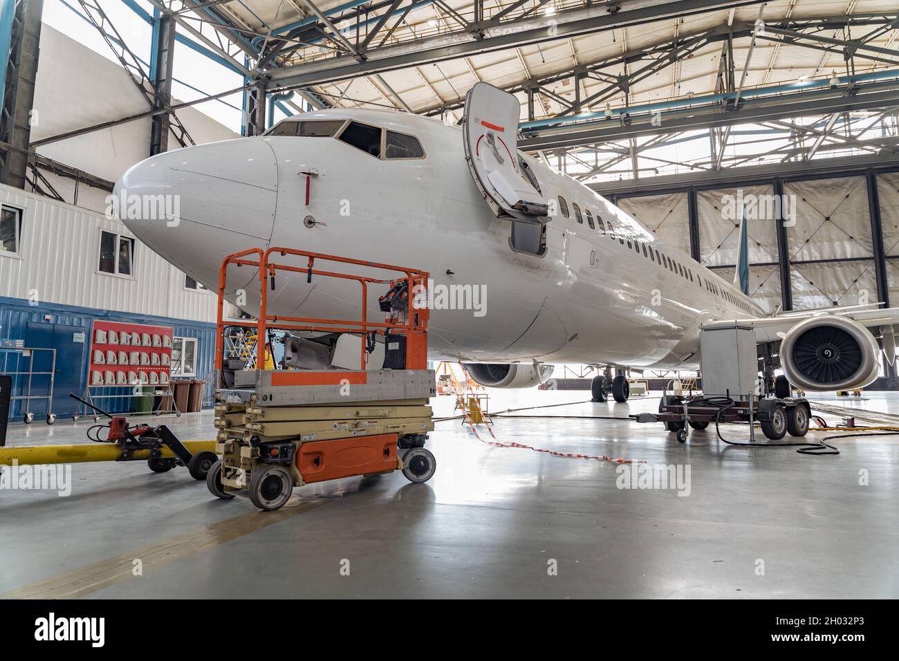 Passenger aircraft on maintenance of engine and fuselage repair in hangar Stock Photo