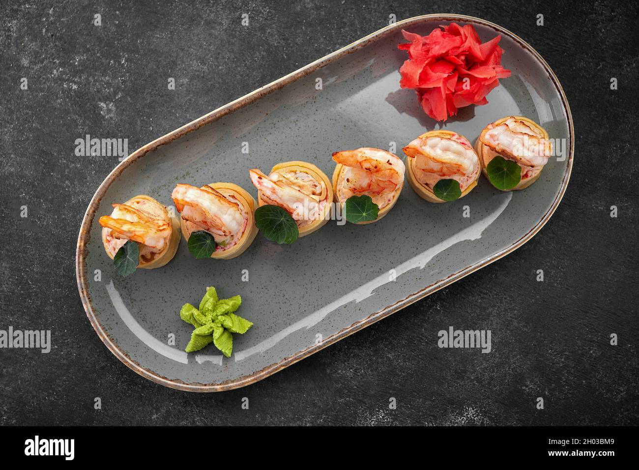 Sushi rolls with omelet, shrimps and crab sticks Stock Photo