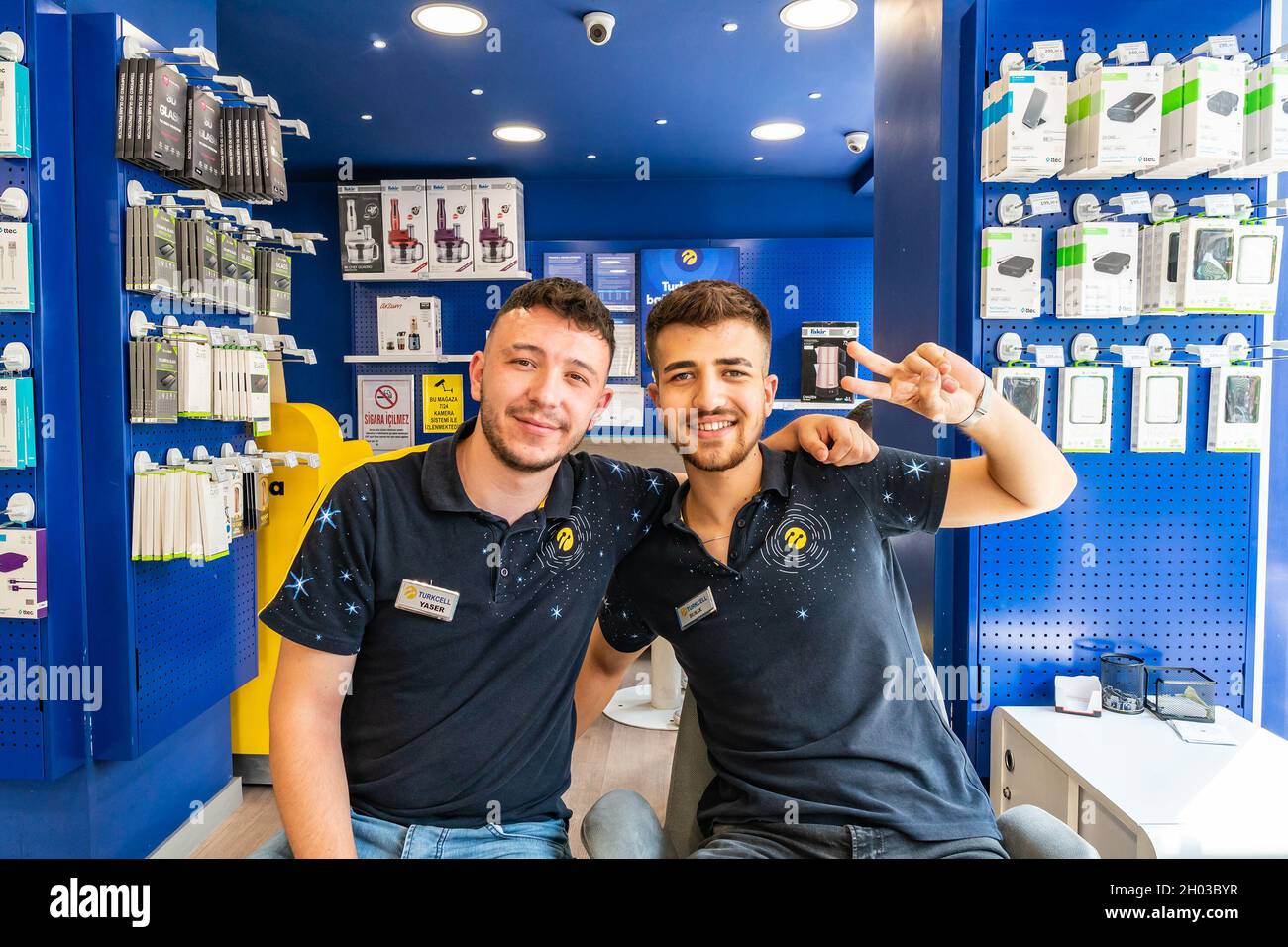 Ankara at Hand Phone Shop two Young Handsome Employees are Sitting and Smiling Stock Photo