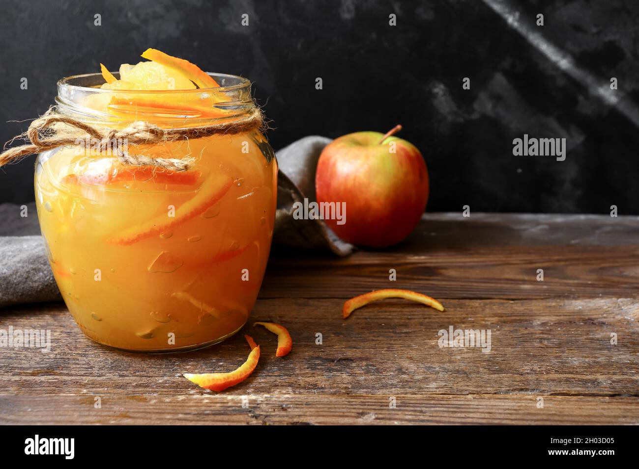 Apple jam in a transparent glass jar. Jam from apples and orange on a